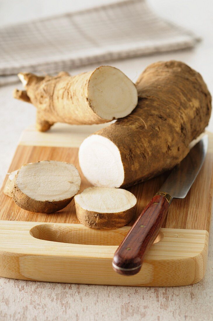 Horseradish, sliced, on a chopping board