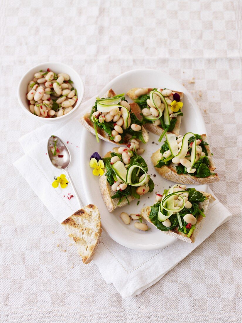 Crostini topped with beans and spinach