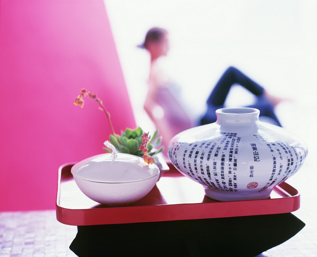 An oil lamp and a porcelain vase with Japanese characters