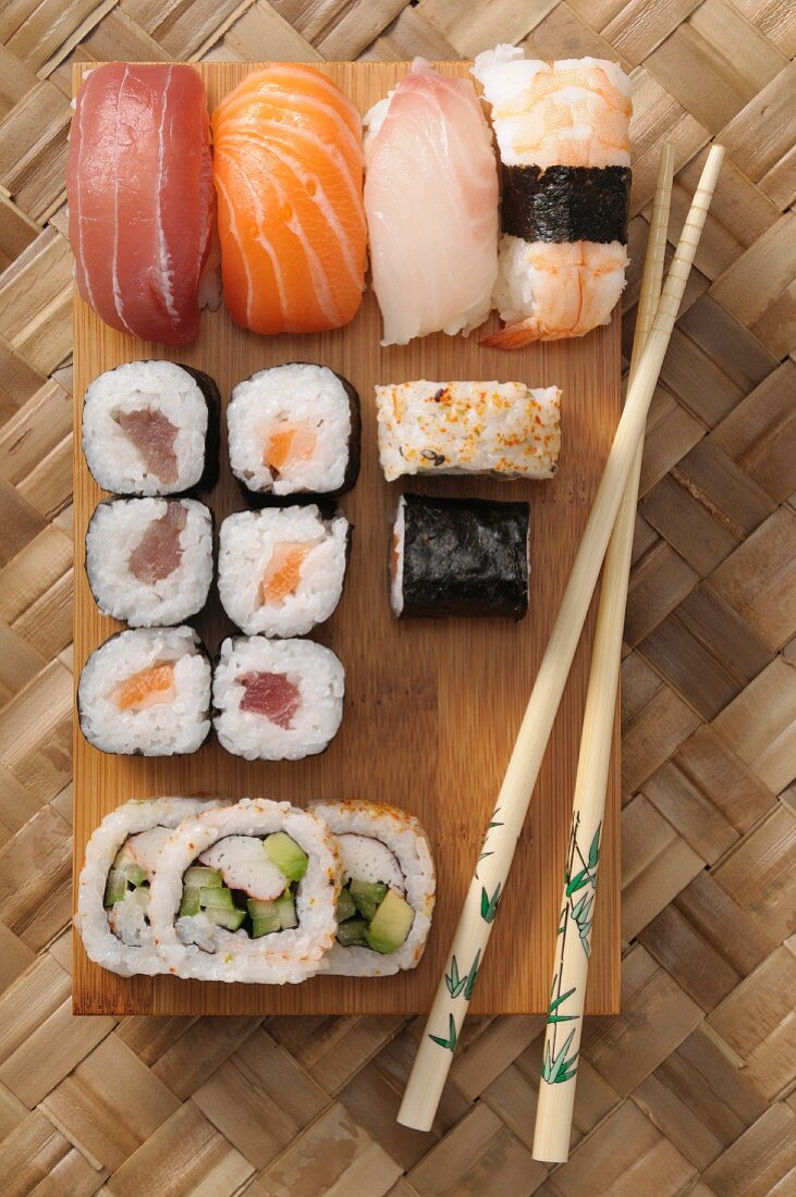Various types of sushi on a wooden board