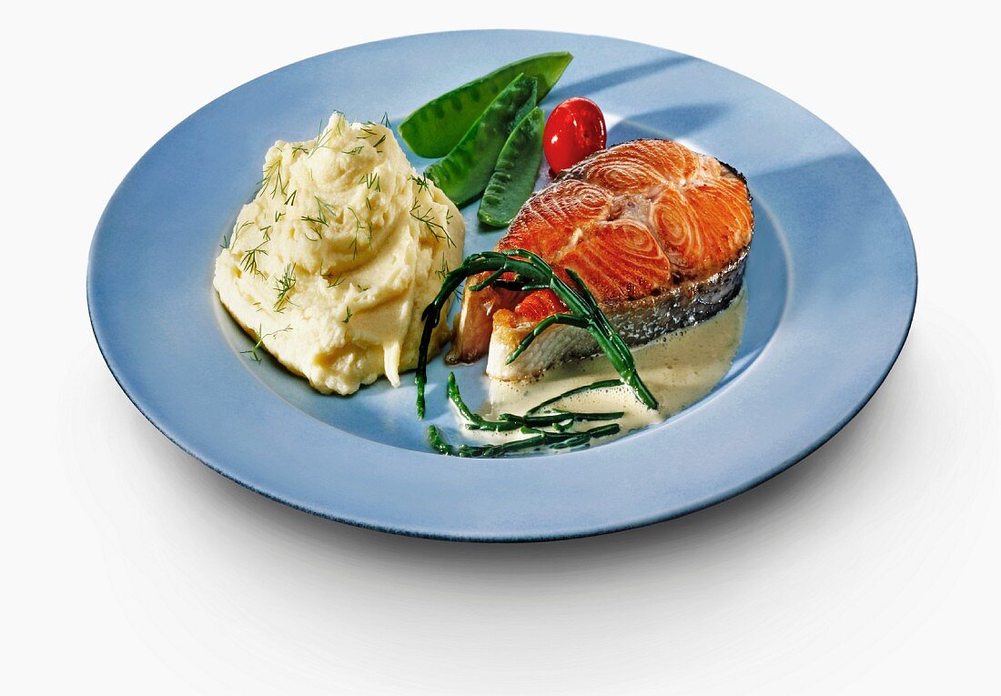 Salmon steak with mashed potatoes and vegetables