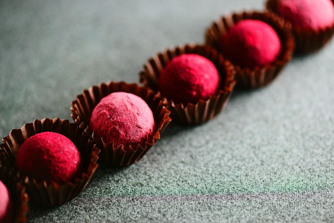A row of pink truffle pralines