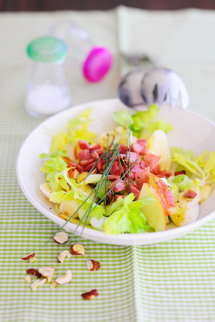 Apple salad with celery, ham and hazelnuts
