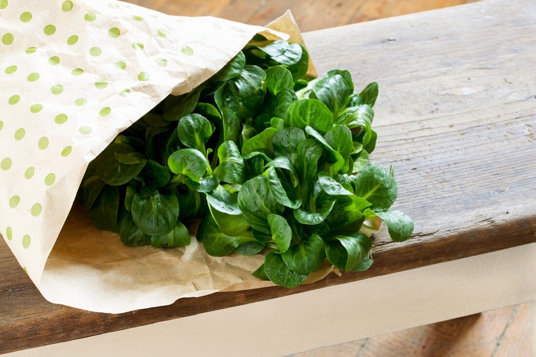 Fresh lamb's lettuce in a paper bag