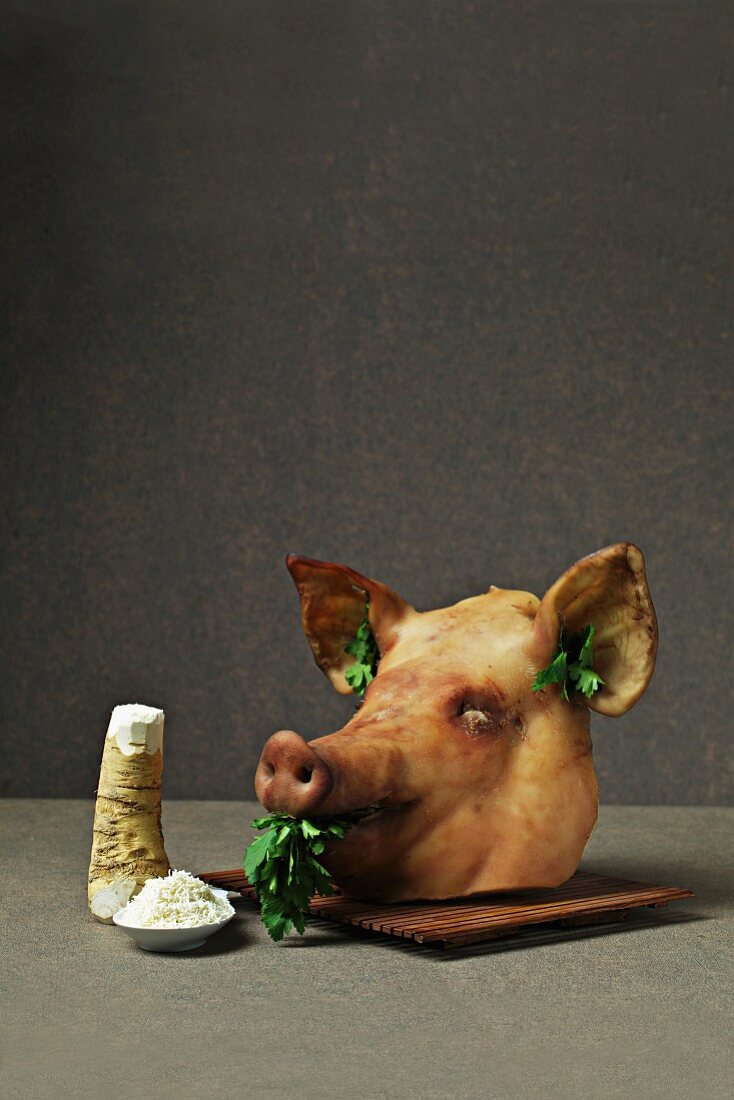 A cooked pig's head with horseradish