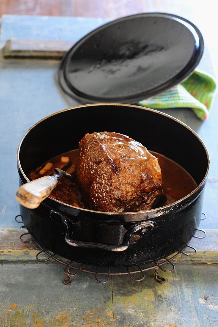 Roast beef in a black roasting tin