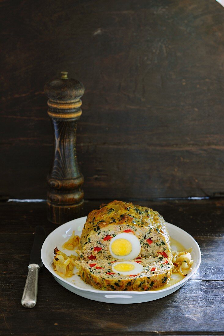 Colourful, vegetarian meatloaf with rice, vegetables and boiled egg