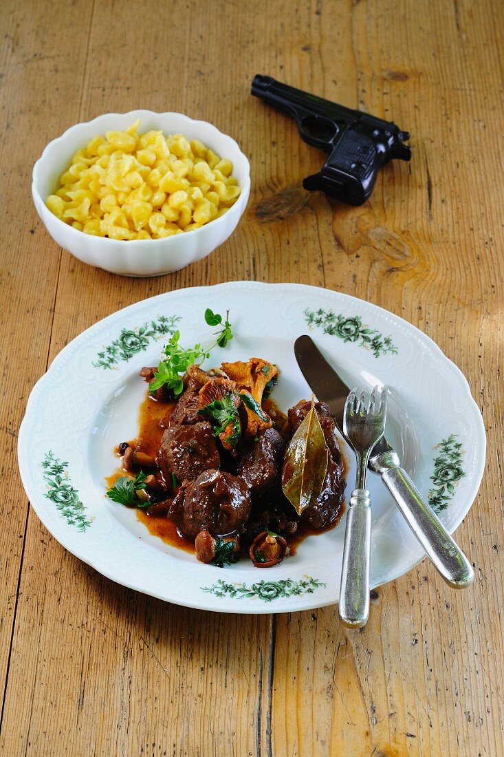 Venison goulash with mushrooms and Spätzle (soft egg noodles from Swabia) next to a pistol