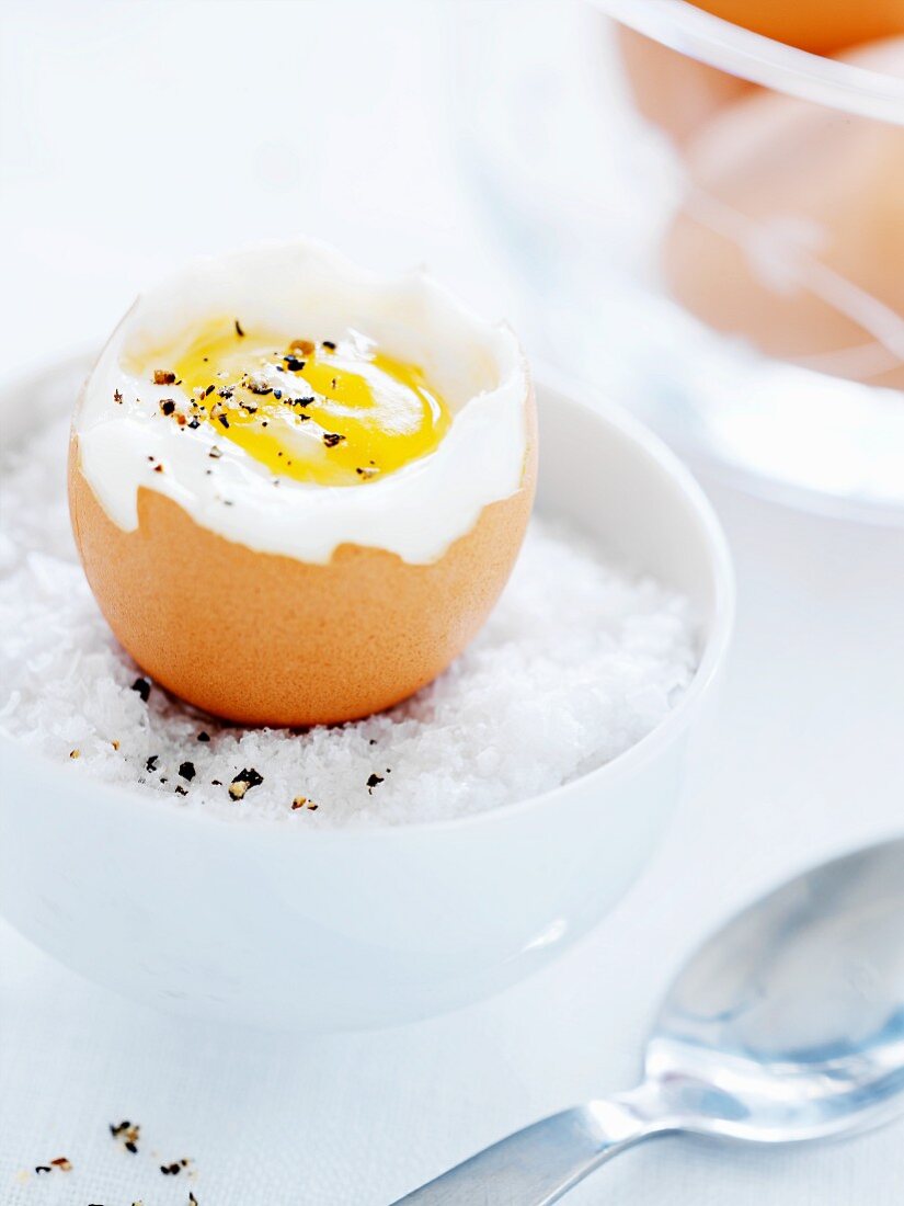 A soft-boiled egg on a bed of salt