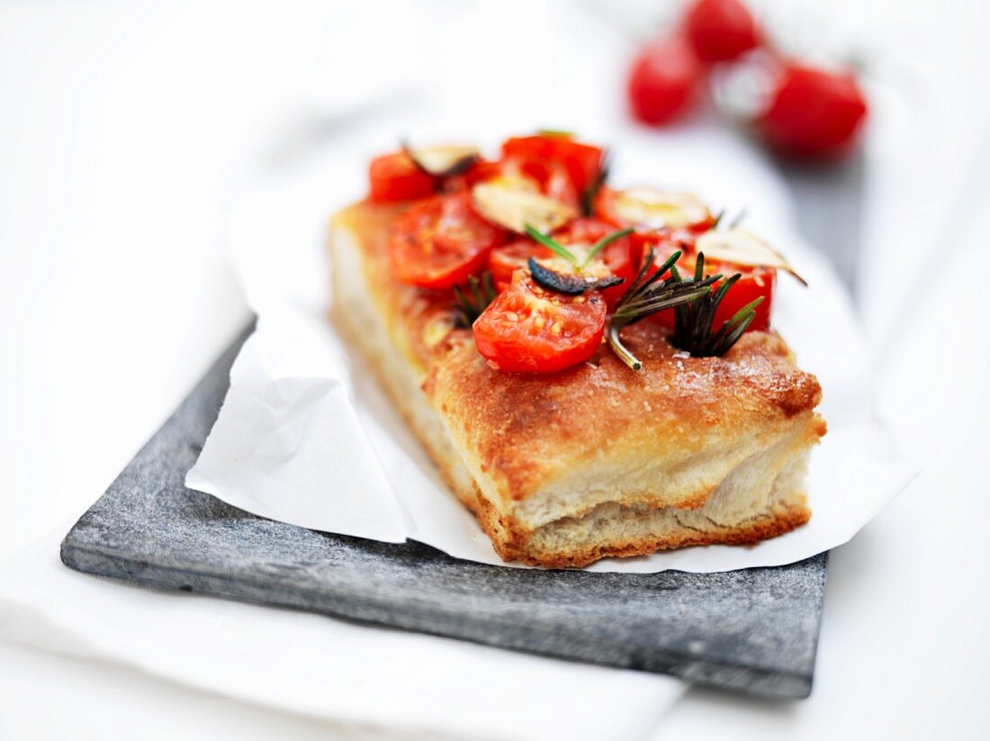 Focaccia topped with tomatoes and rosemary