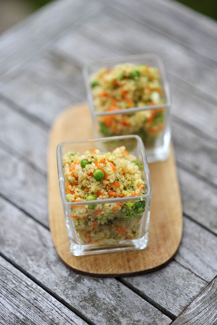 Quinoa salad with vegetables in two glass bowls