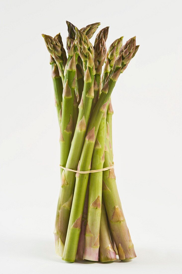 A bunch of green asparagus against a white background