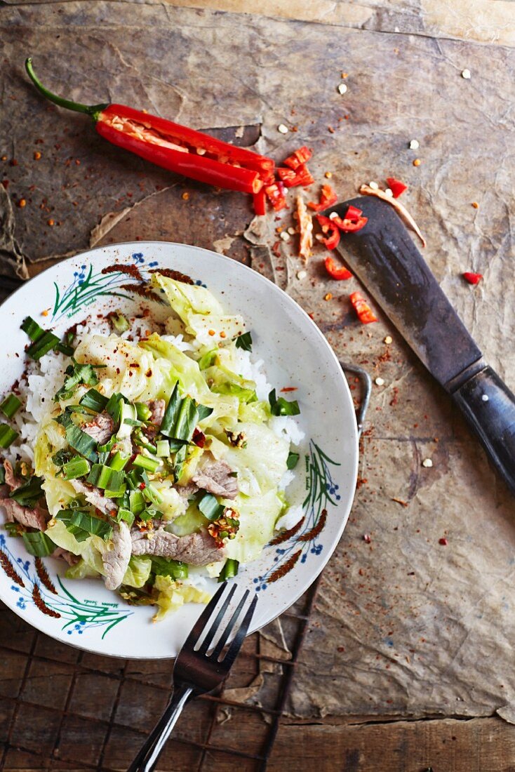Pad-kla-lam-plee (braised white cabbage on a bed of rice with pork and spices, Thailand)