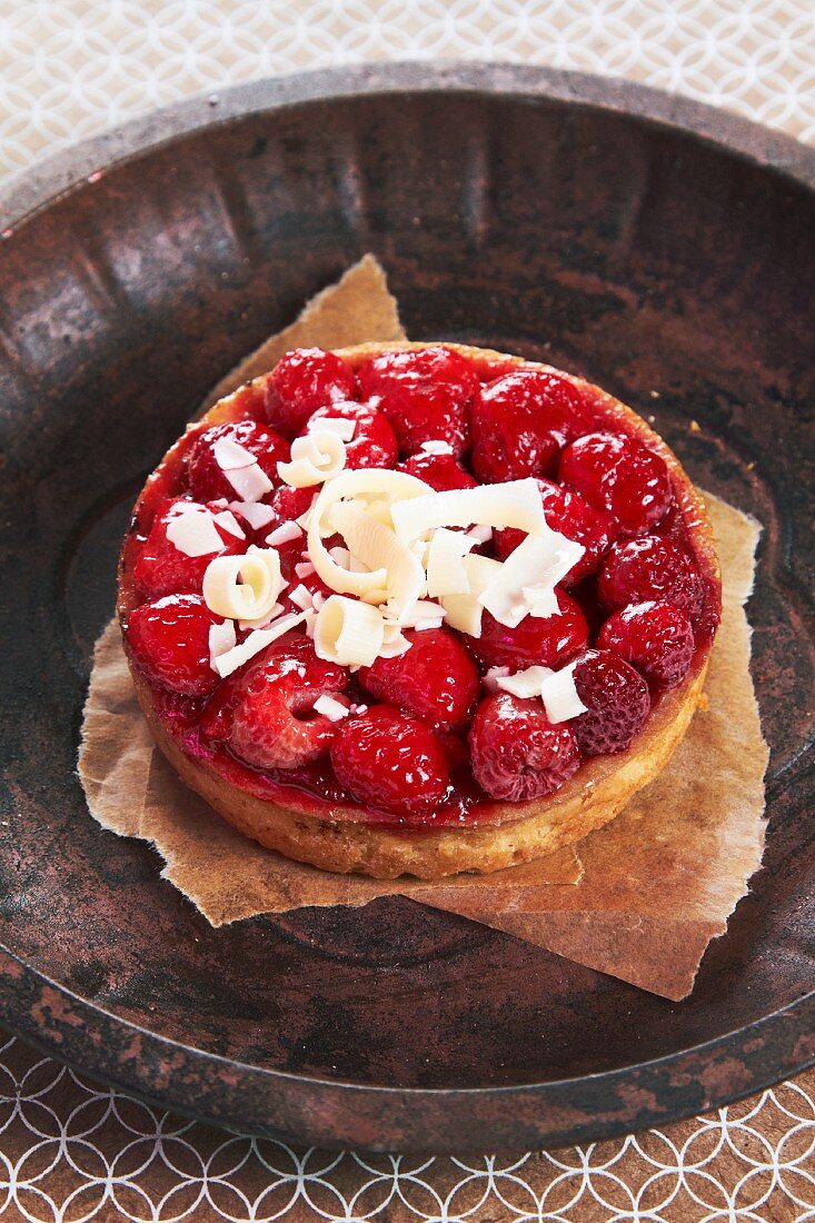 A raspberry tartlet topped with white chocolate