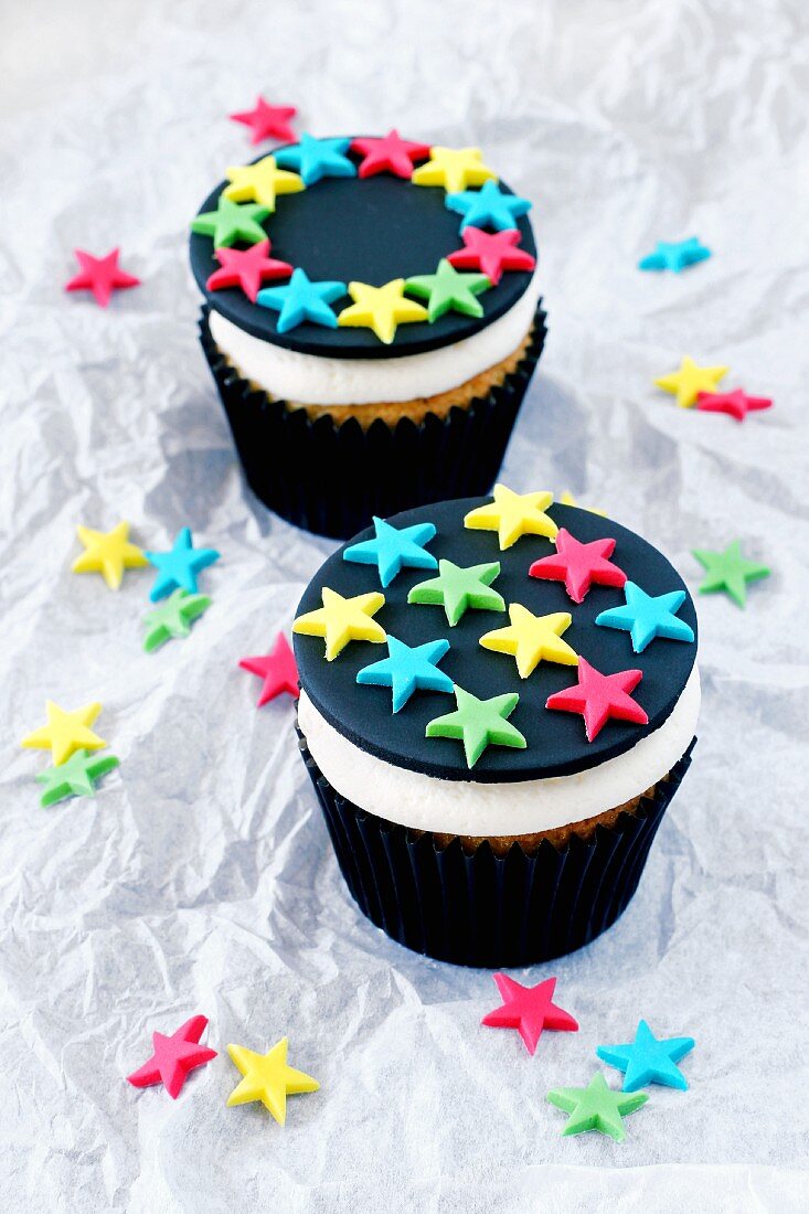 Two lemon cupcakes decorated with stars