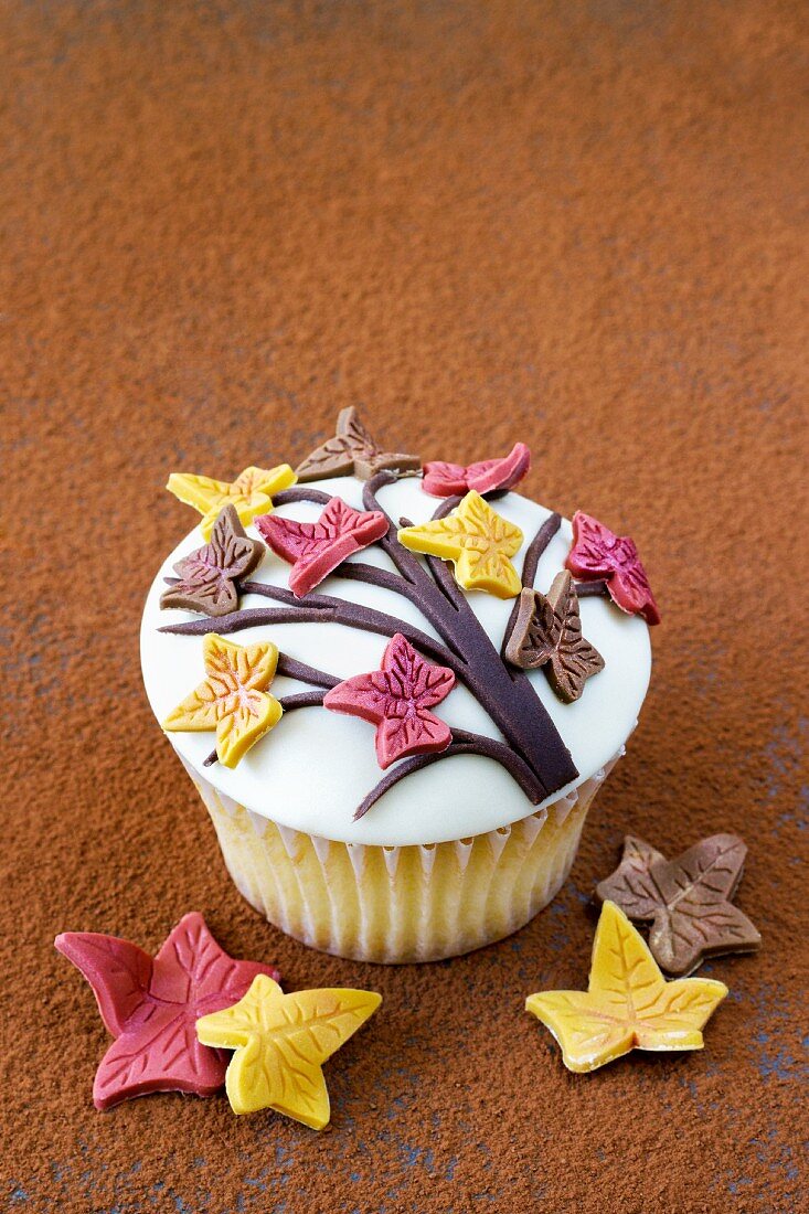 A spiced cupcake decorated with sugar leaves