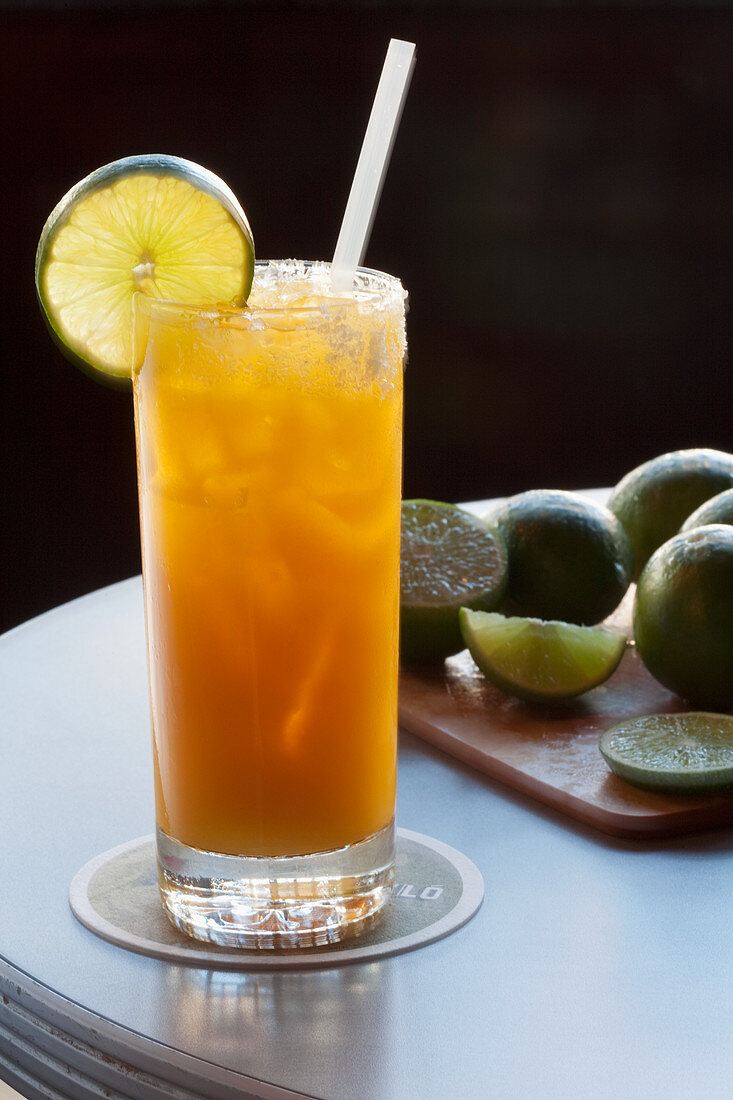 Orange juice-based cocktail garnished with lime