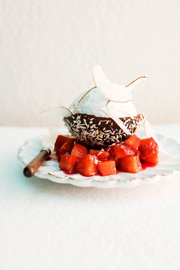 Coconut sorbet in a chocolate bowl with strawberry compote