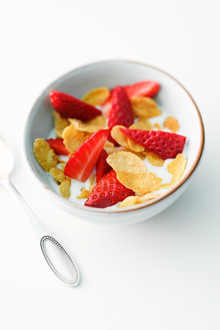 Bowl of Flake Cereal Topped with Fresh Strawberries