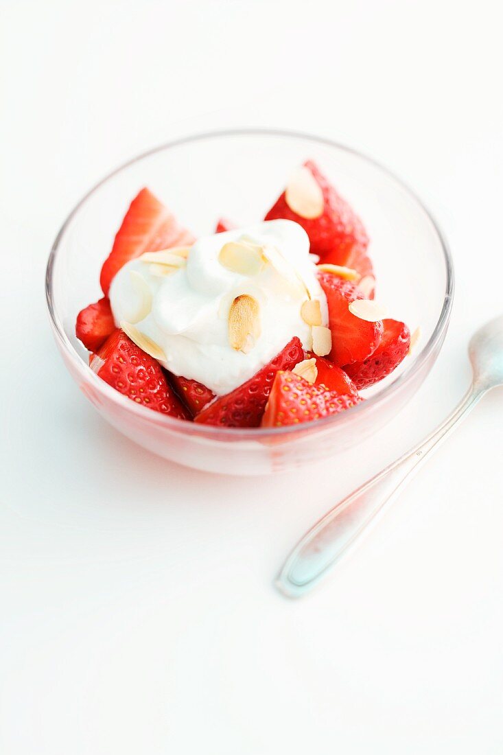 Fresh strawberries with cream and almonds