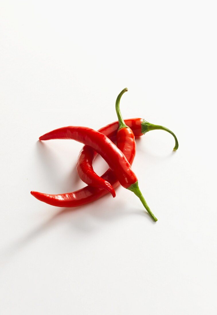 Three fresh red chilli peppers