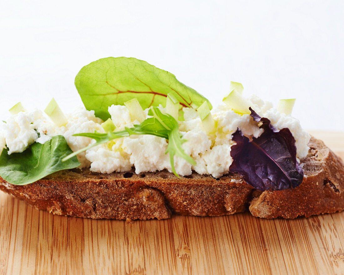 Soft cheese and herbs on bread