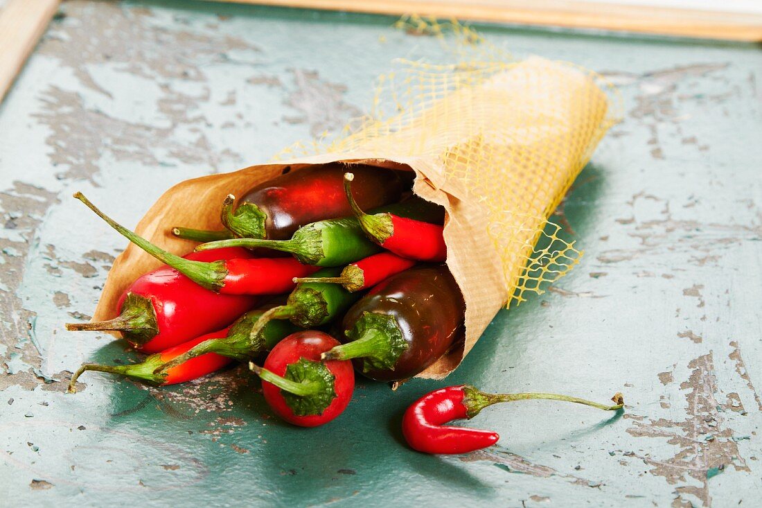A paper bag of fresh chilli peppers