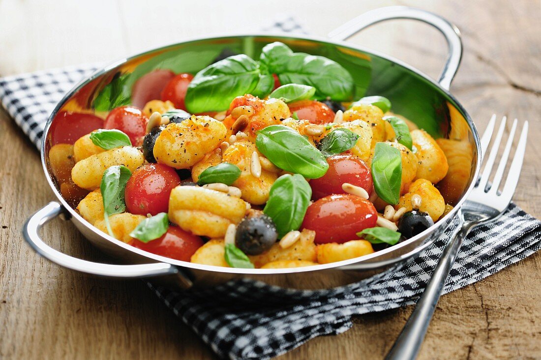 Gnocchi with tomatoes, olives, pine nuts and basil