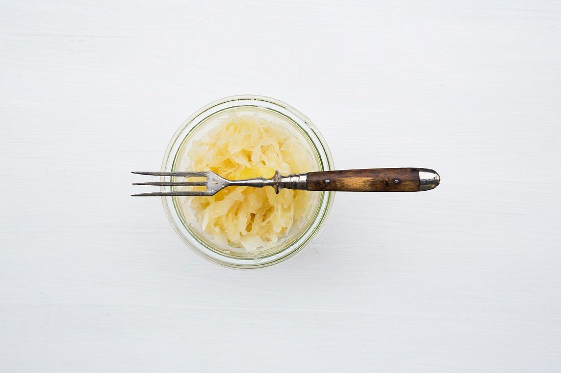 Sauerkraut in a jar with a fork