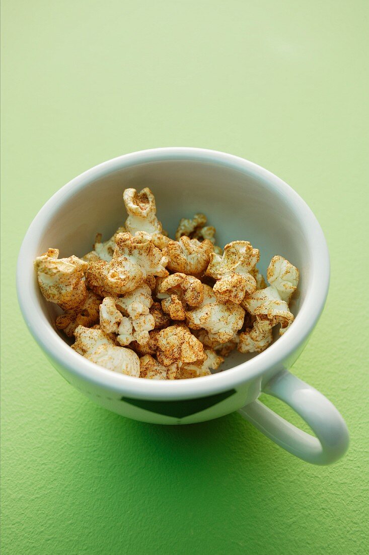 Spiced popcorn in a football cup