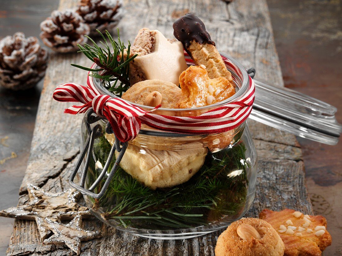 Various Christmas biscuits in a glass jar