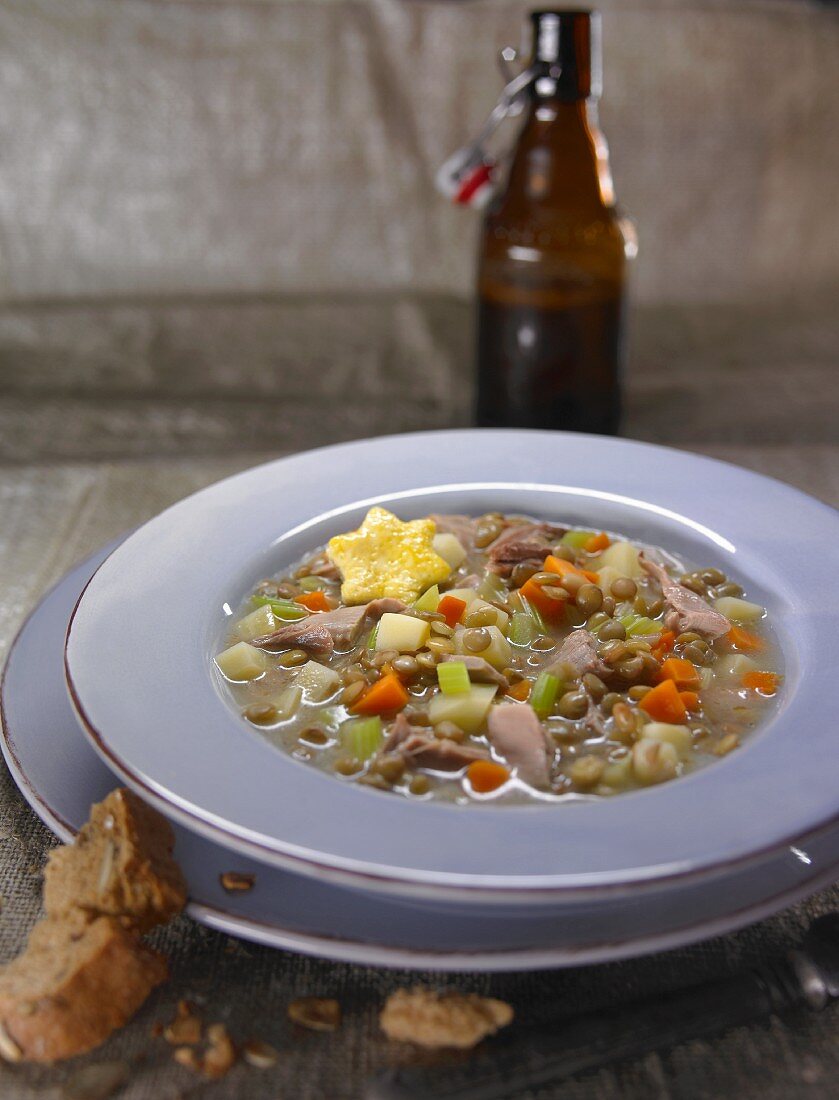 Pheasant soup with peas, carrots and potatoes