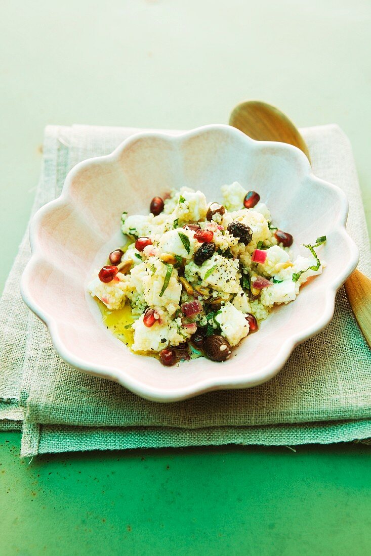 Couscous salad with beans, sheep's cheese and pomegranate seeds