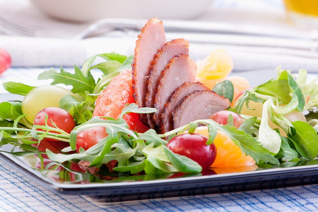 Goose breast with oranges, grapes, grapefruit and rocket