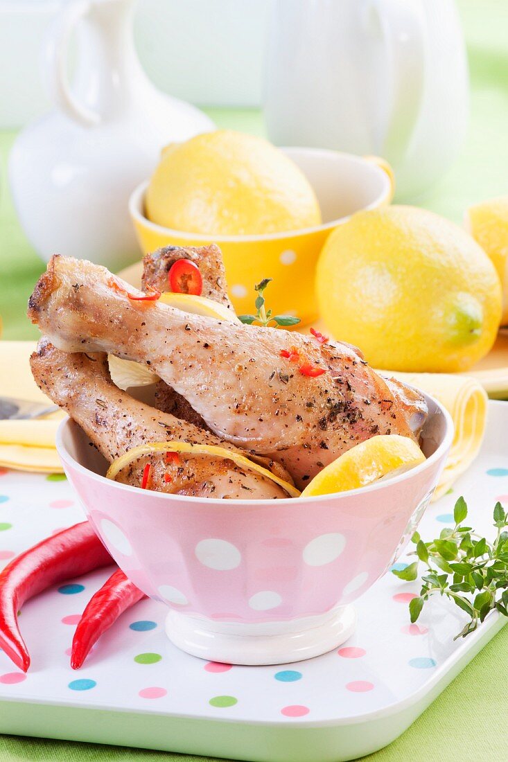 Baked chicken legs with lemon and chilli peppers