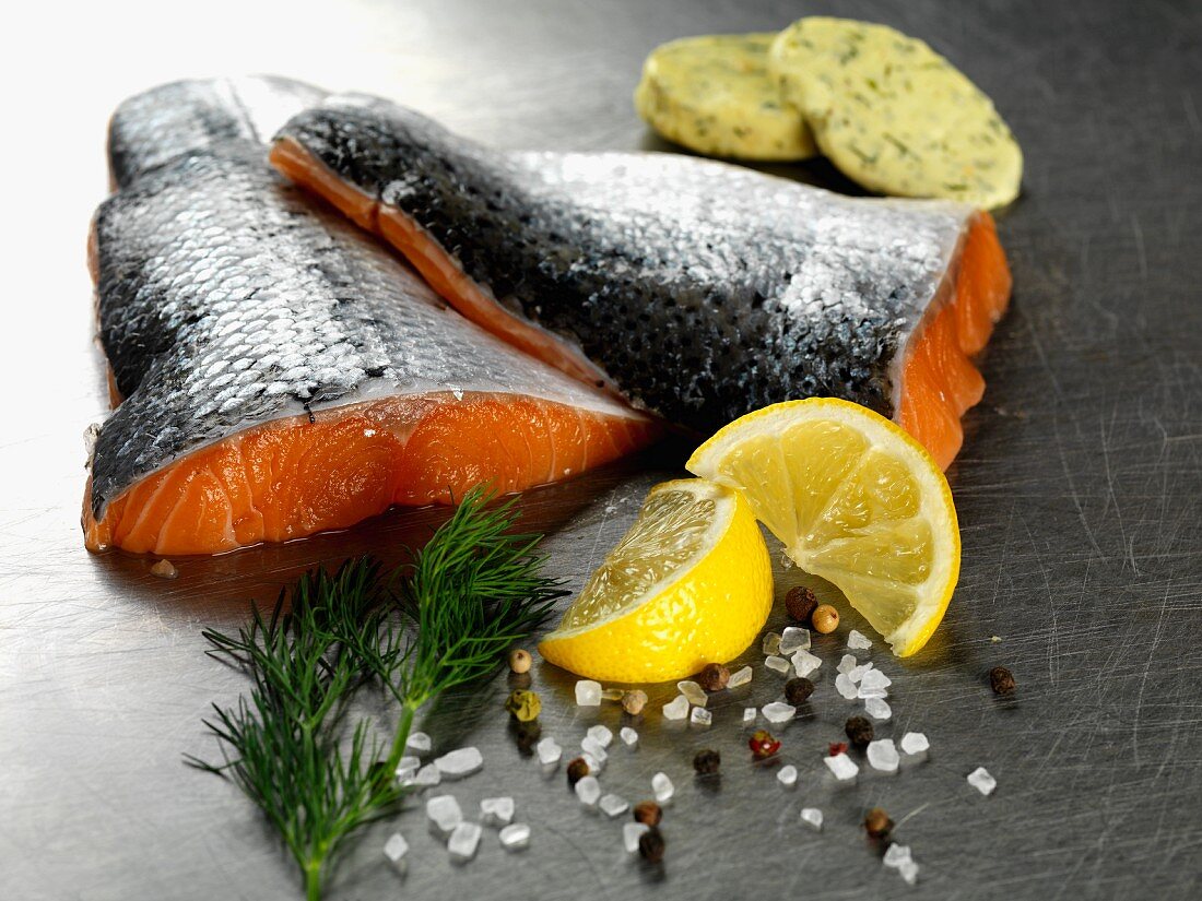 Salmon fillets with herb butter, lemon, dill, salt and pepper