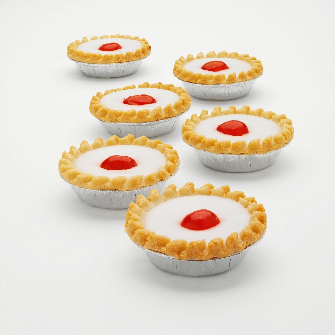 Cherry Bakewell tarts in foil cases