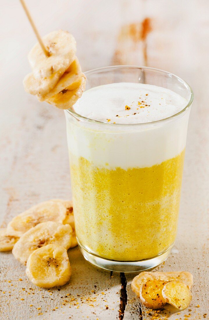A banana smoothie with milk foam