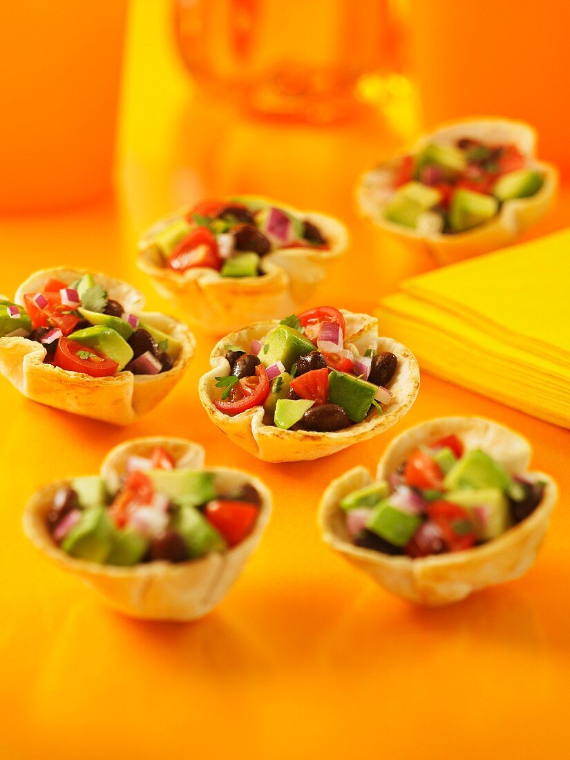 Pastry cups filled with avocado salsa