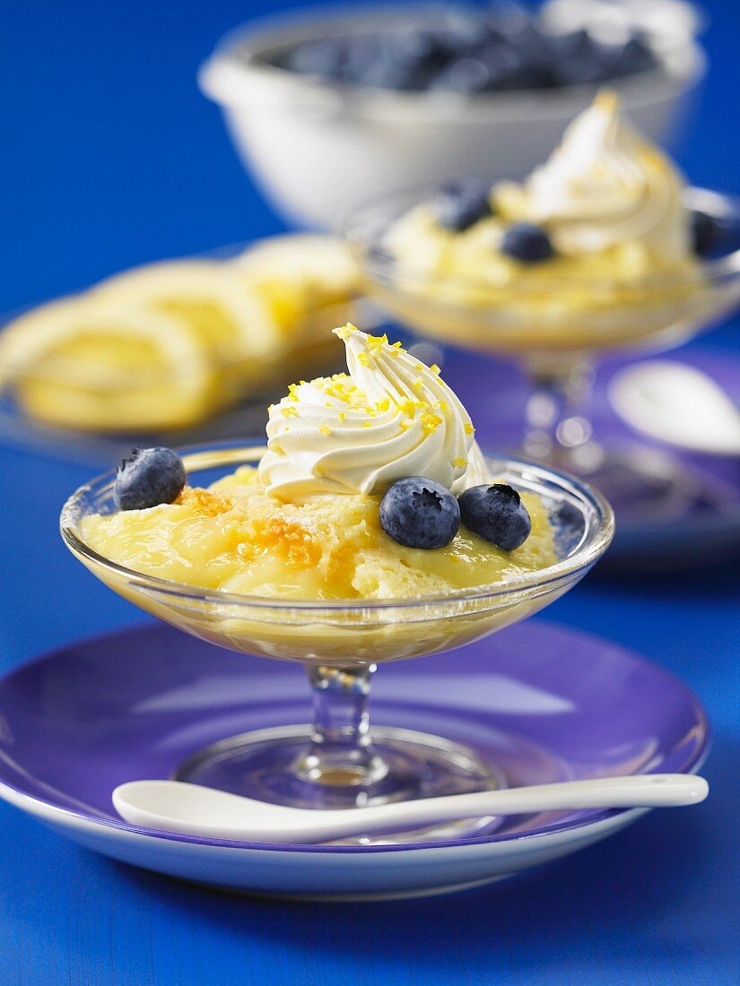 Lemon pudding with blueberries and a dollop of cream