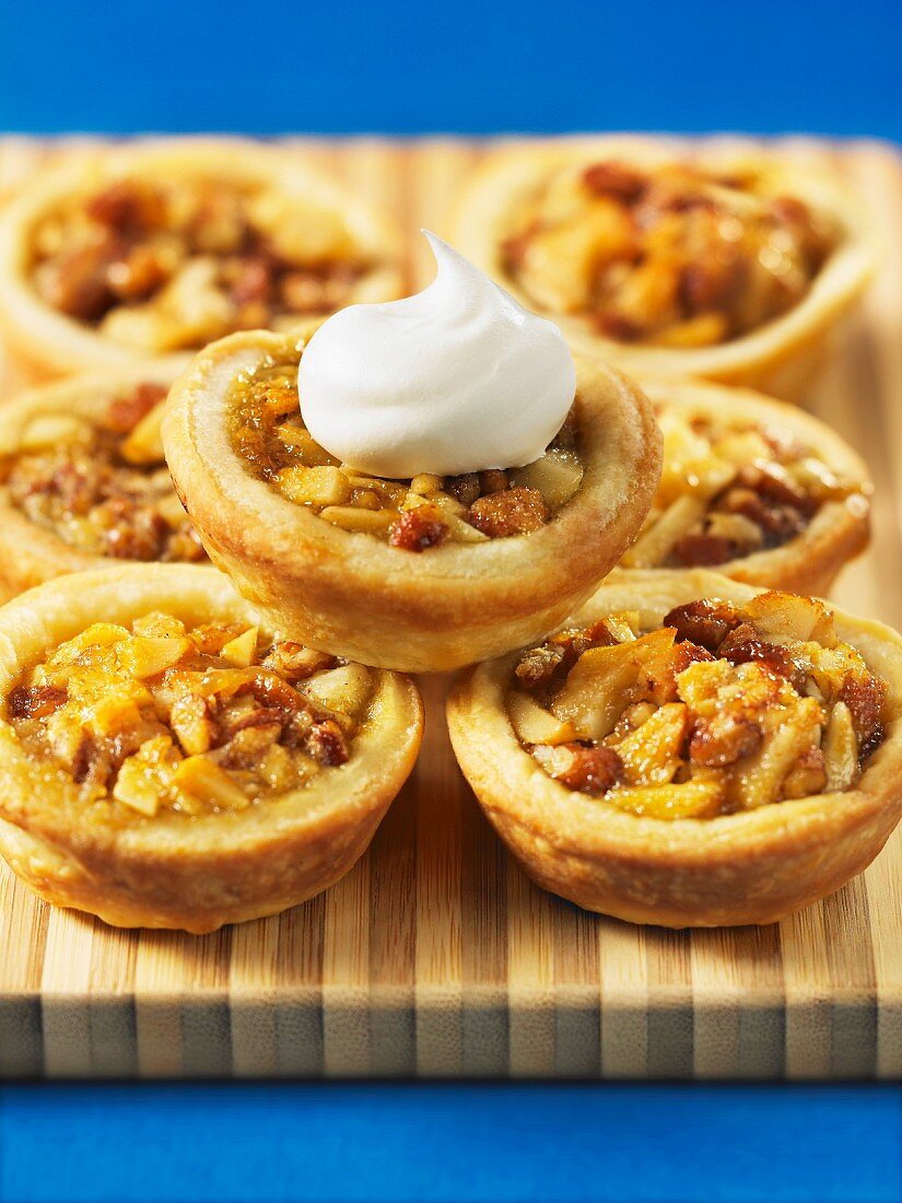 Nut tartlets with a dollop of cream