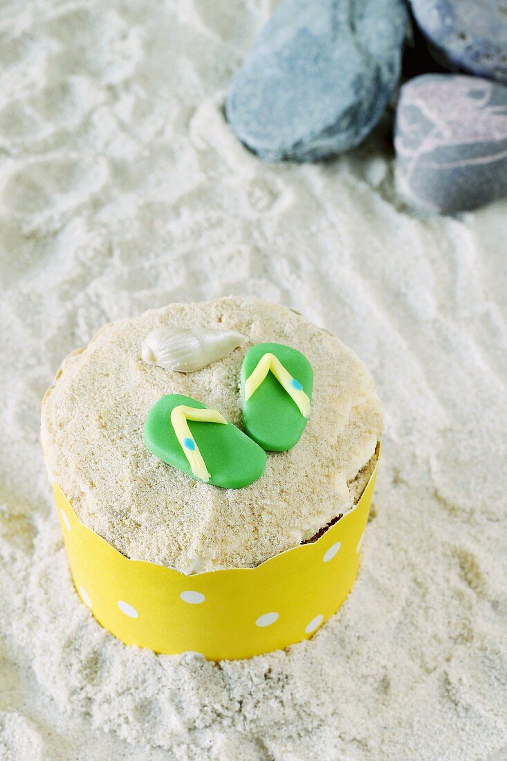 A cupcake decorated with flip-flops