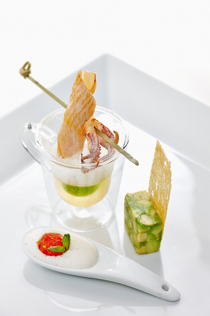 Avocado soup with an octopus skewer and asparagus terrine