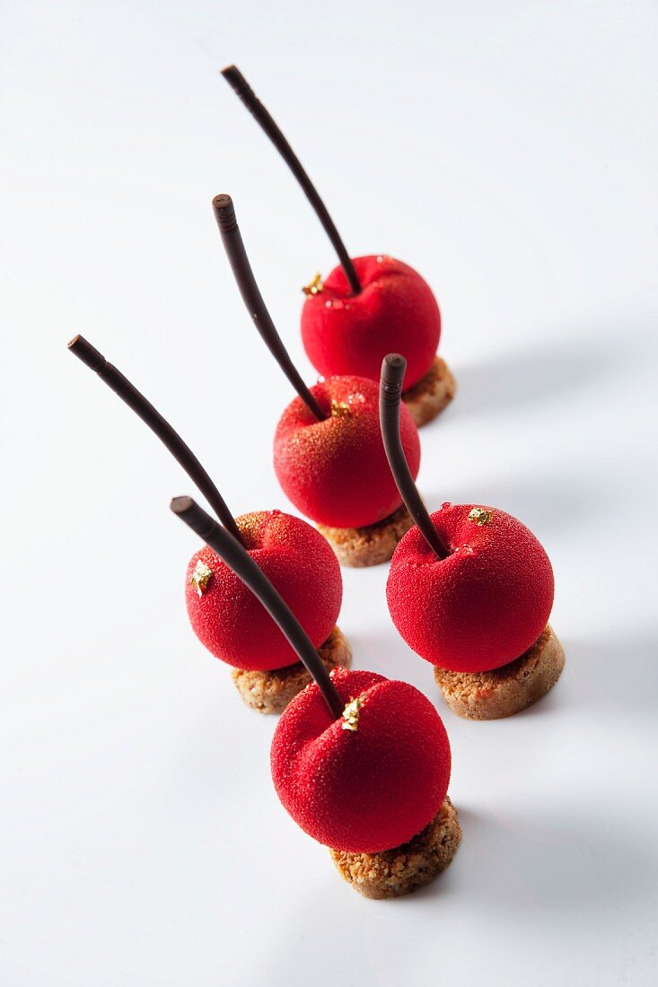 Marzipan cherries decorated with gold leaf
