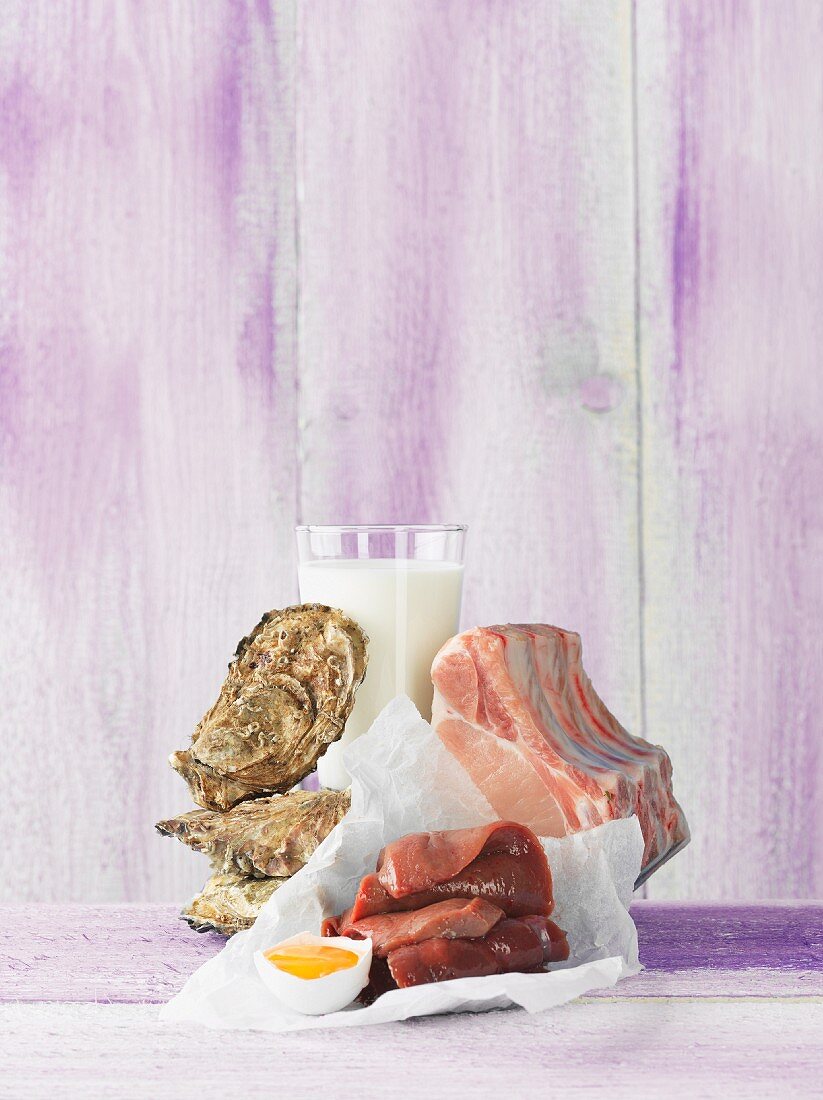 An arrangement featuring oysters, milk, an egg and pork