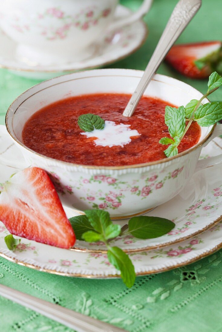 Strawberry and tapioca summer soup with mint in porcelain cups