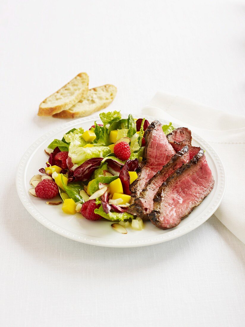 Beefsteak with a colourful salad and bread