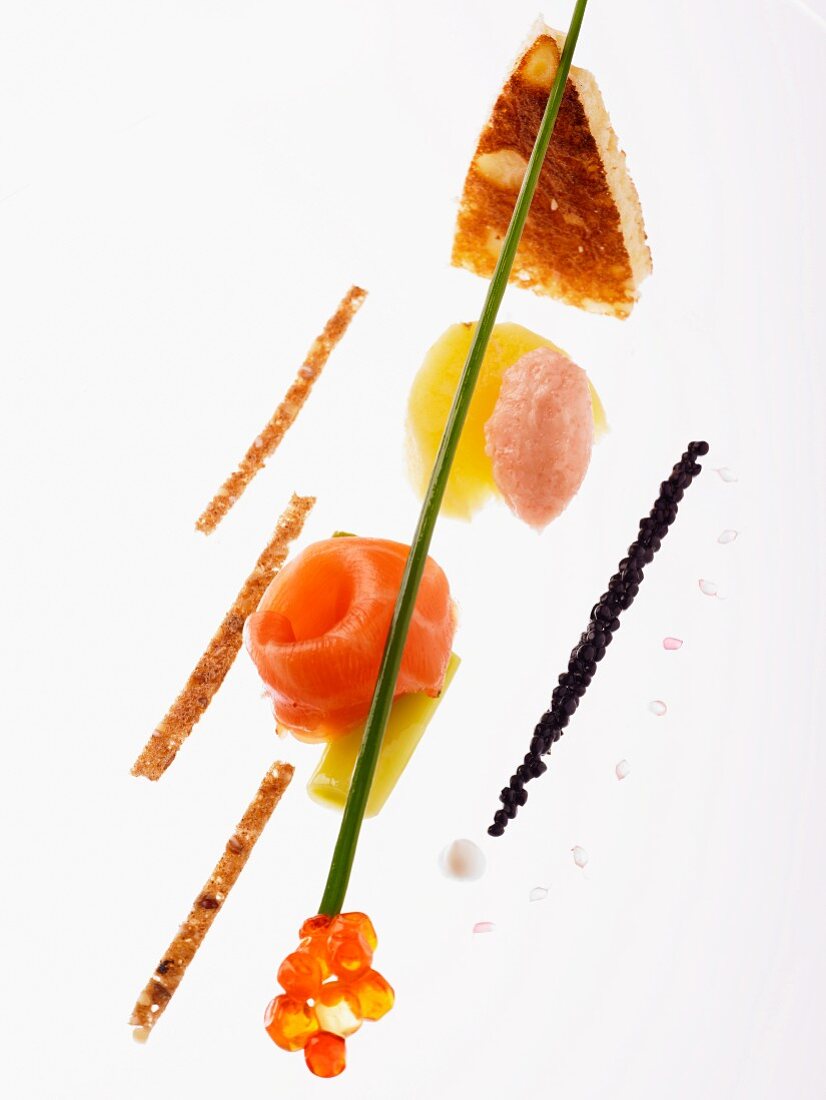 An artistic arrangement of smoked salmon, tamaras, salmon caviar and strips of toast