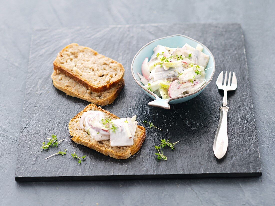 Herring salad with apple and radishes on homemade bread