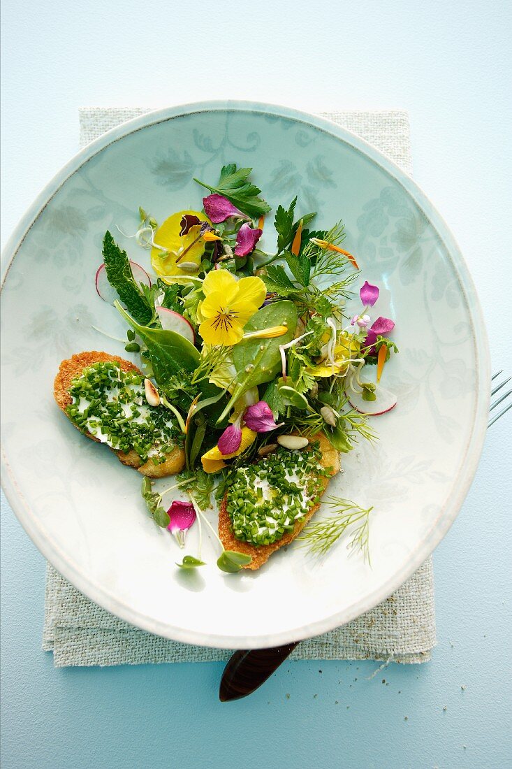 Spicy herb salad with flowers and chive croutons